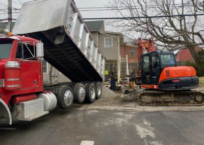 Dump truck unloading soil at excavation site