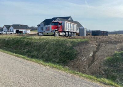 Dump truck delivering gravel to construction site